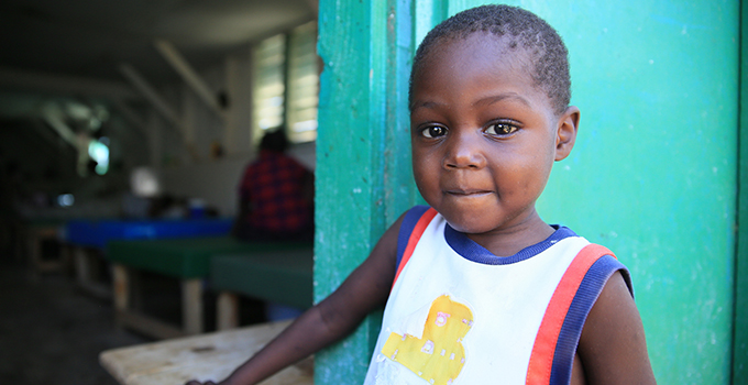 Photo of a small boy against a door.