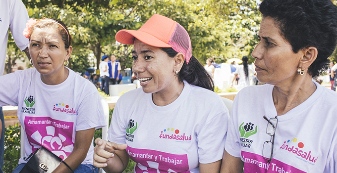 Photo of three women engaging in an outdoor activity.