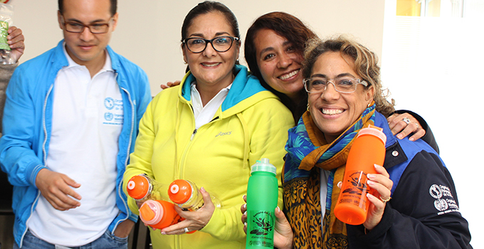 Photo of a group of women smiling and holding water bottles